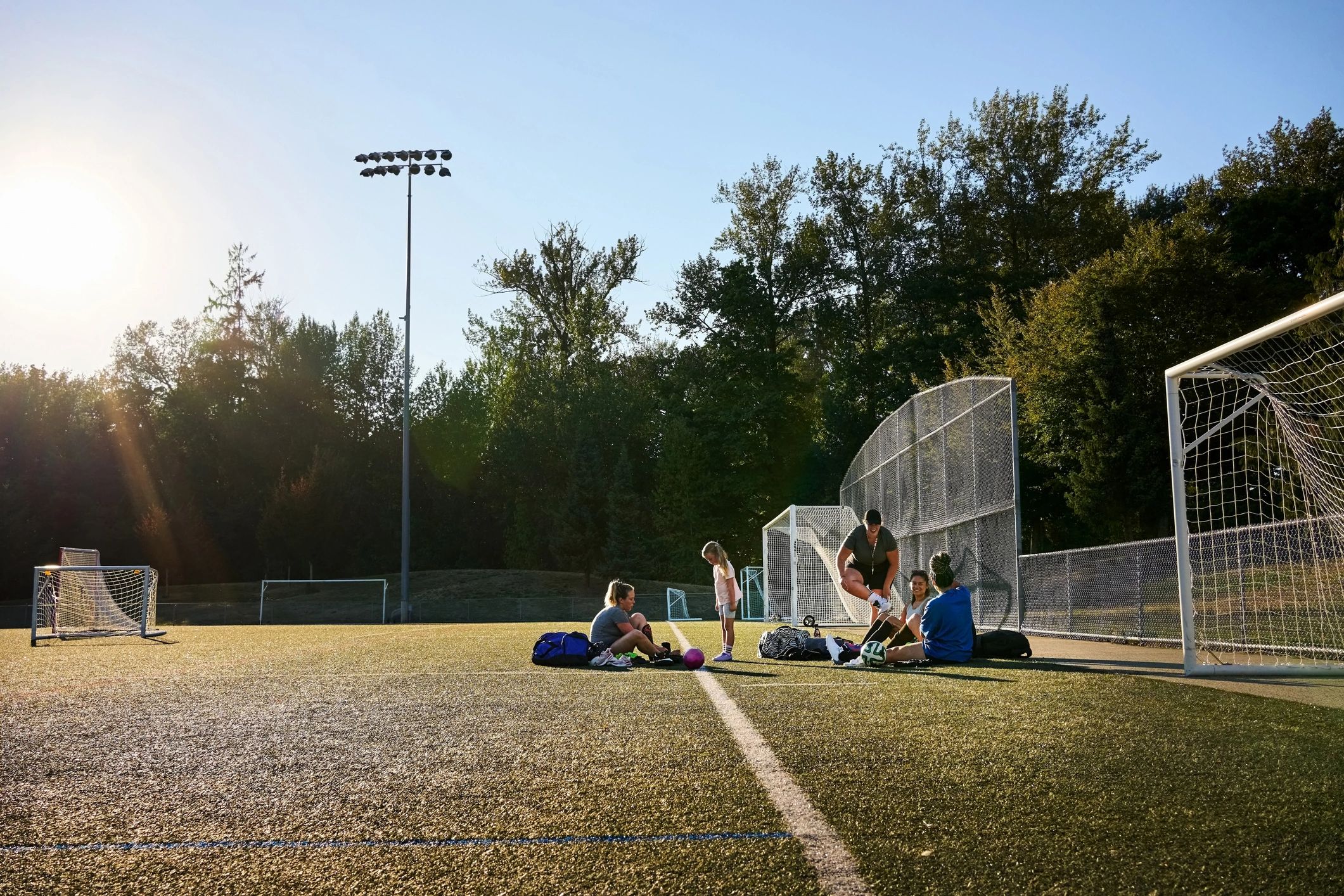 Youth athletes gathering on a field before practice